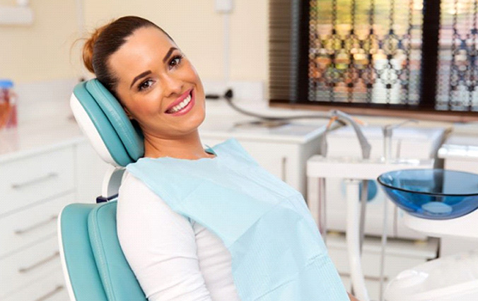 smiling dental patient in treatment chair