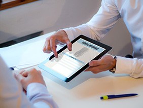 Patient reviewing dental insurance form on tablet
