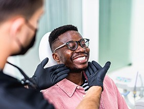 Dentist looking at patient's smile in treatment chair