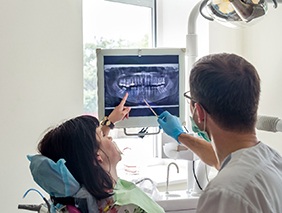 Dentist in Broken Arrow and patient looking at X-rays