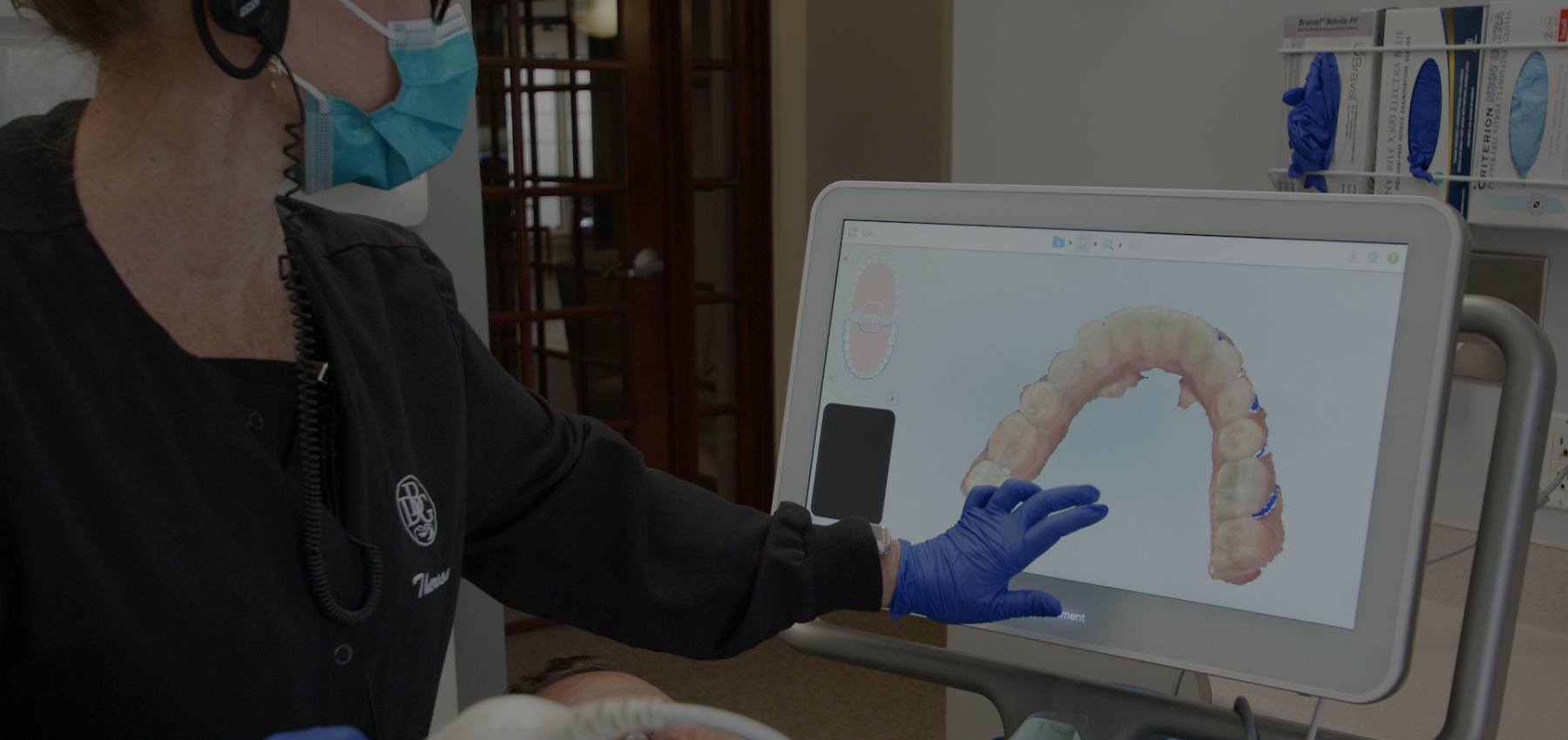 Dentist looking at digital impressions on chairside computer