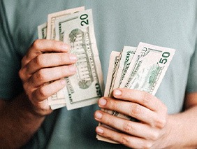 Close up of man’s hands counting cash