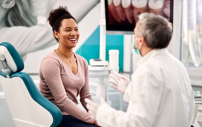 dentist talking to patient about cosmetic dentistry in Broken Arrow