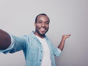 happy man with fixed implant dentures 