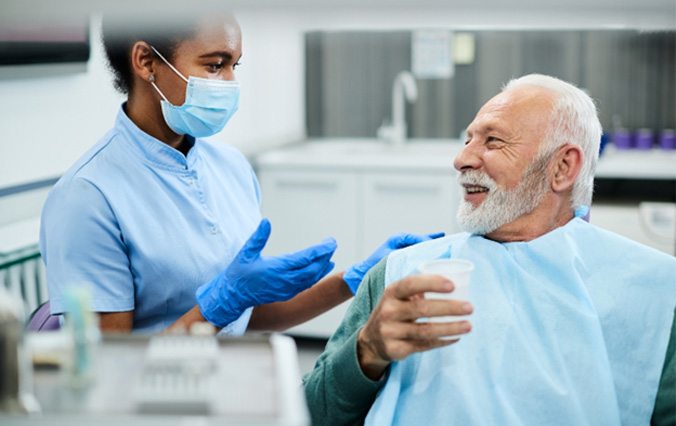 man learning about the implant dentures process