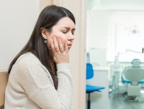 Woman with toothache holding cheek