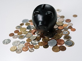 Black piggy bank on coins