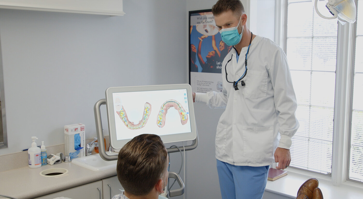 Dentist showing a patient digital models of their teeth on computer screen in Broken Arrow