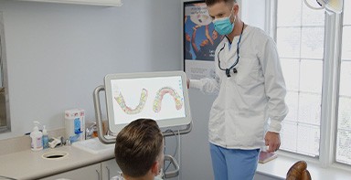 Dentist showing a patient digital models of their teeth on computer screen in Broken Arrow