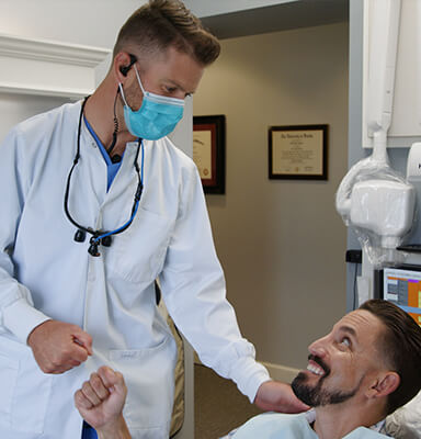 Dentist smiling at dental patient