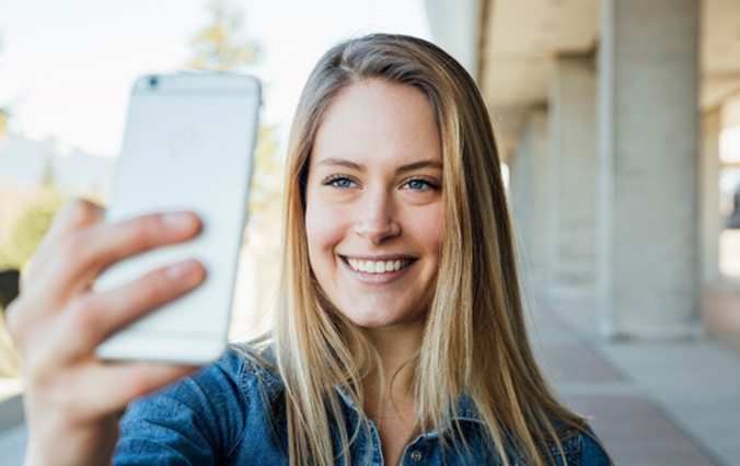 young woman taking selfie with smartphone