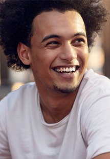 a man smiling after undergoing orthodontic treatment