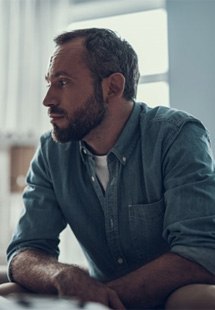 a man sitting down and worried