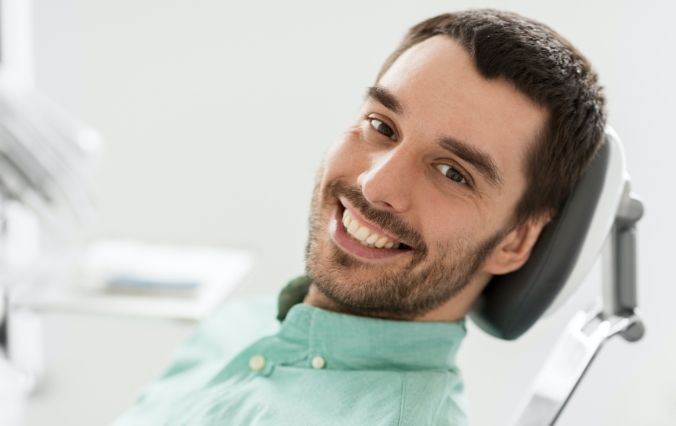Man smiling during prevnetive dentistry checkup and teeth cleaning