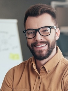 Man smiling after sleep apnea treatment visit