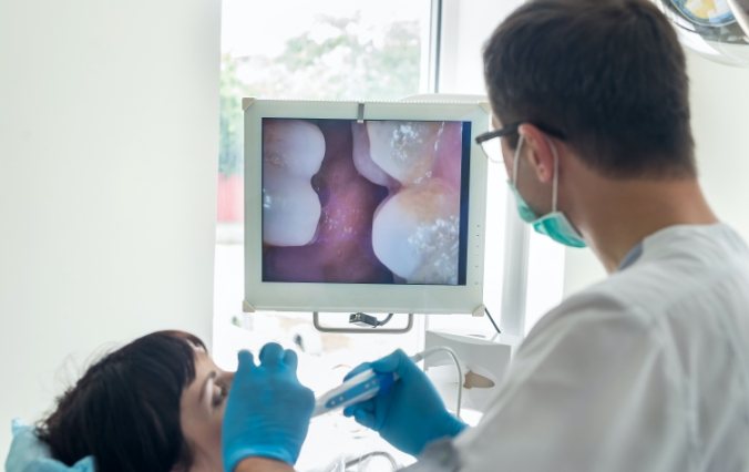 Dentist using intraoral camera to capture images