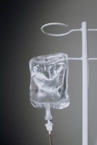 IV bag hanging from white stand