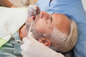 Man sleeping in dental chair while being treated