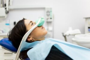Woman receiving sedation at dentist's office.