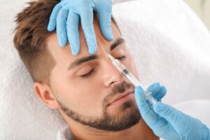 Man getting cosmetic injection between his eyebrows