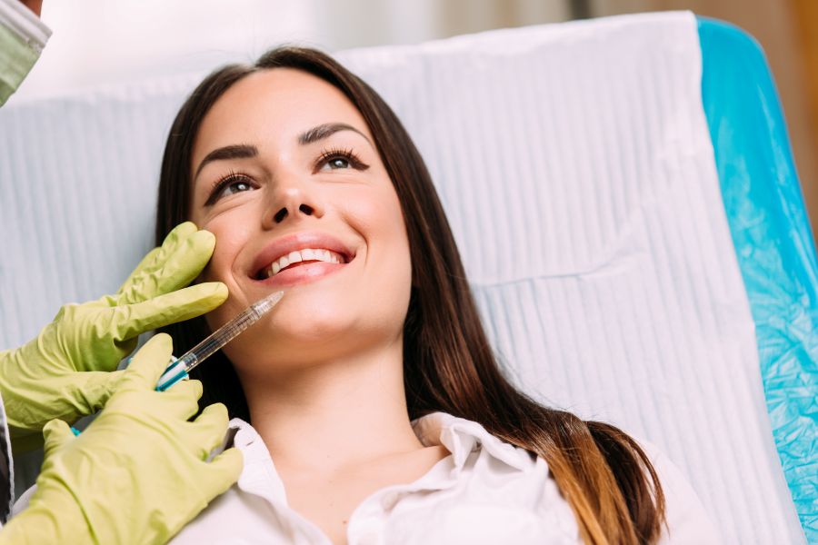 A woman getting dermal fillers in her lips